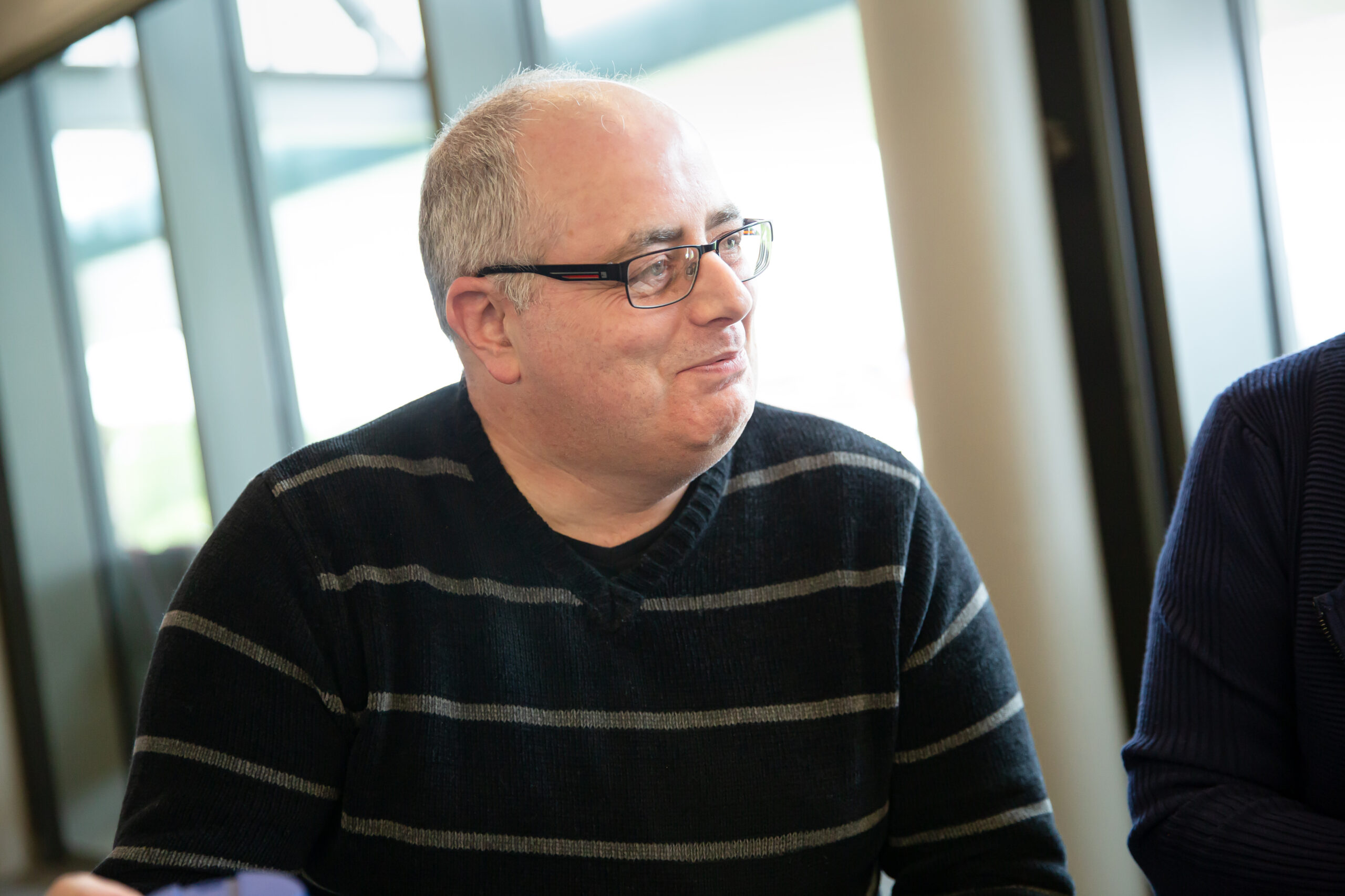 a man in a black and gray striped sweater.