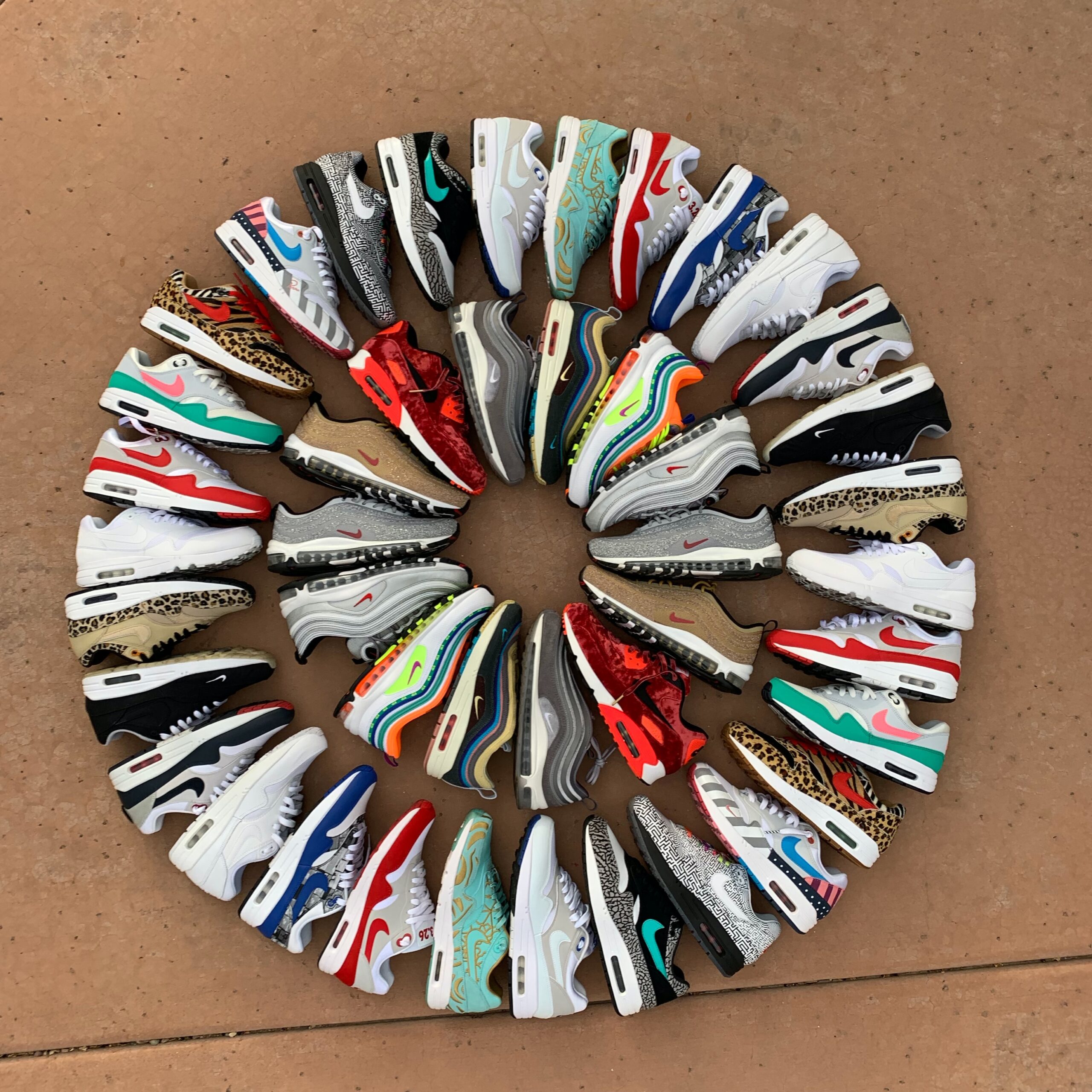 a circular arrangement of shoes on a tile floor.