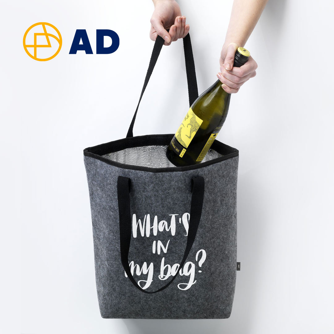 Somebody placing a bottle of wine inside a bag