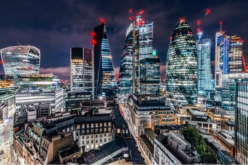 the city of london at night with the lights on.