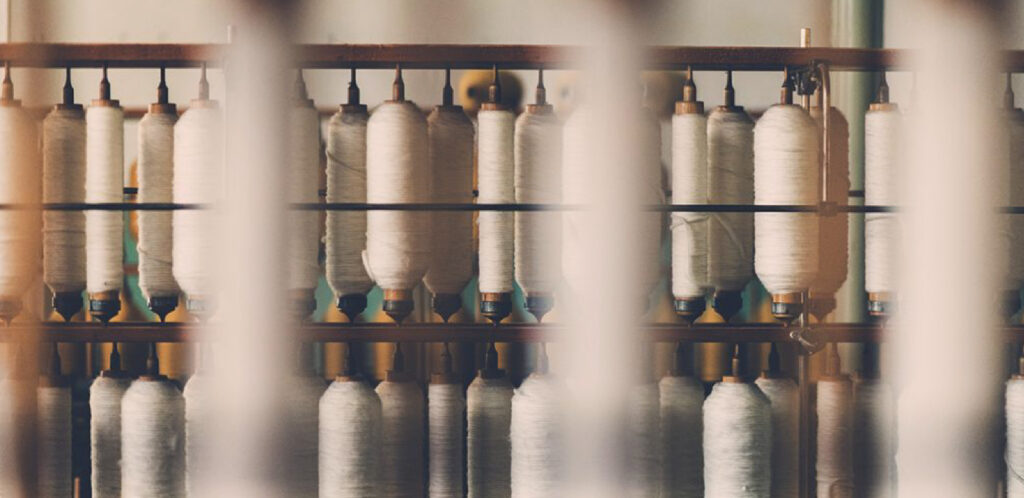 An image of some machinery with fabric spindles