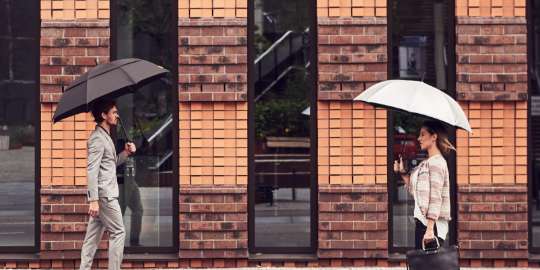 2 people with umbrellas